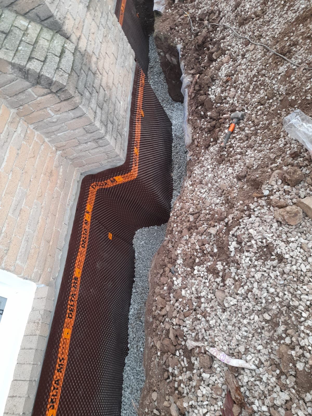 Exterior foundation membrane and drainage trench in Barrie